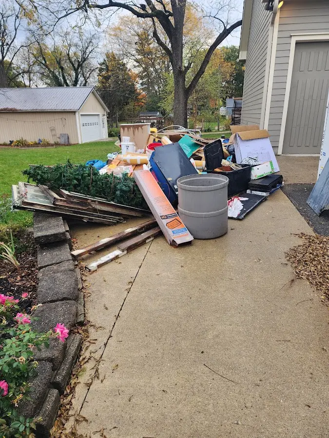 Dumpster being loaded with debris for Estate Cleanout Dumpster Rental in Bradley Beach